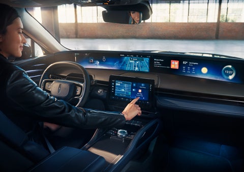 The driver of a 2024 Lincoln Nautilus® SUV interacts with the center touchscreen. | Bill Knight Lincoln in Tulsa OK